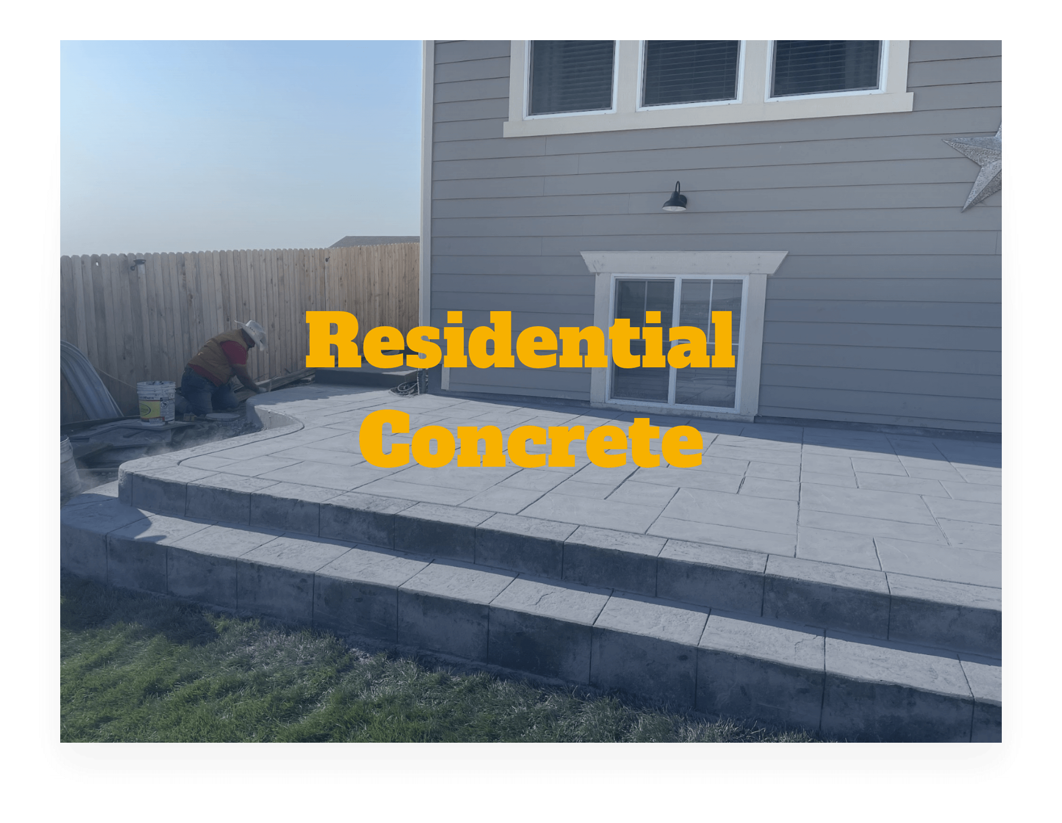 Man laying concrete finish to backyard concrete patio