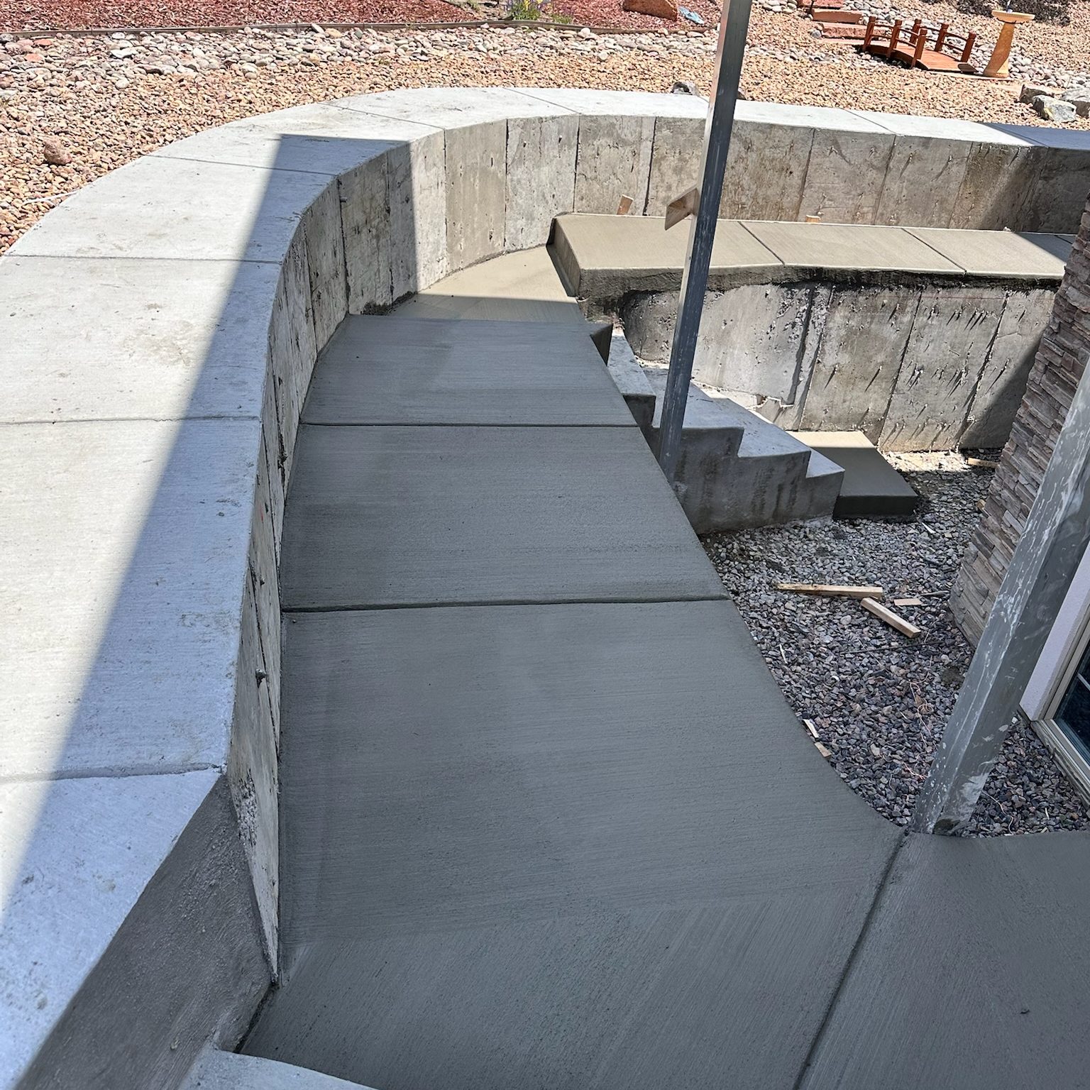 backyard retaining wall with stairs surrounding house