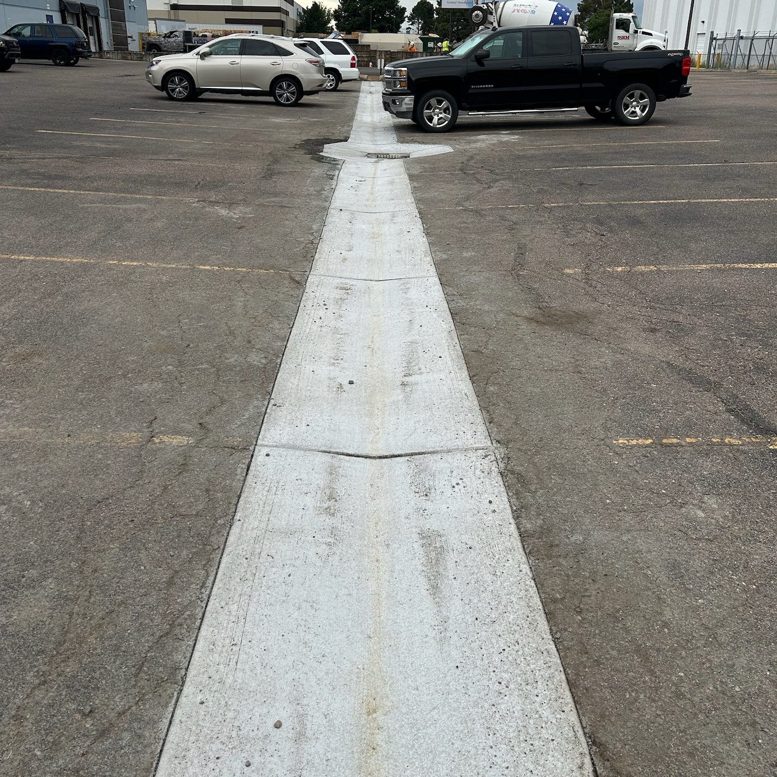 paved driveway between grass lawn
